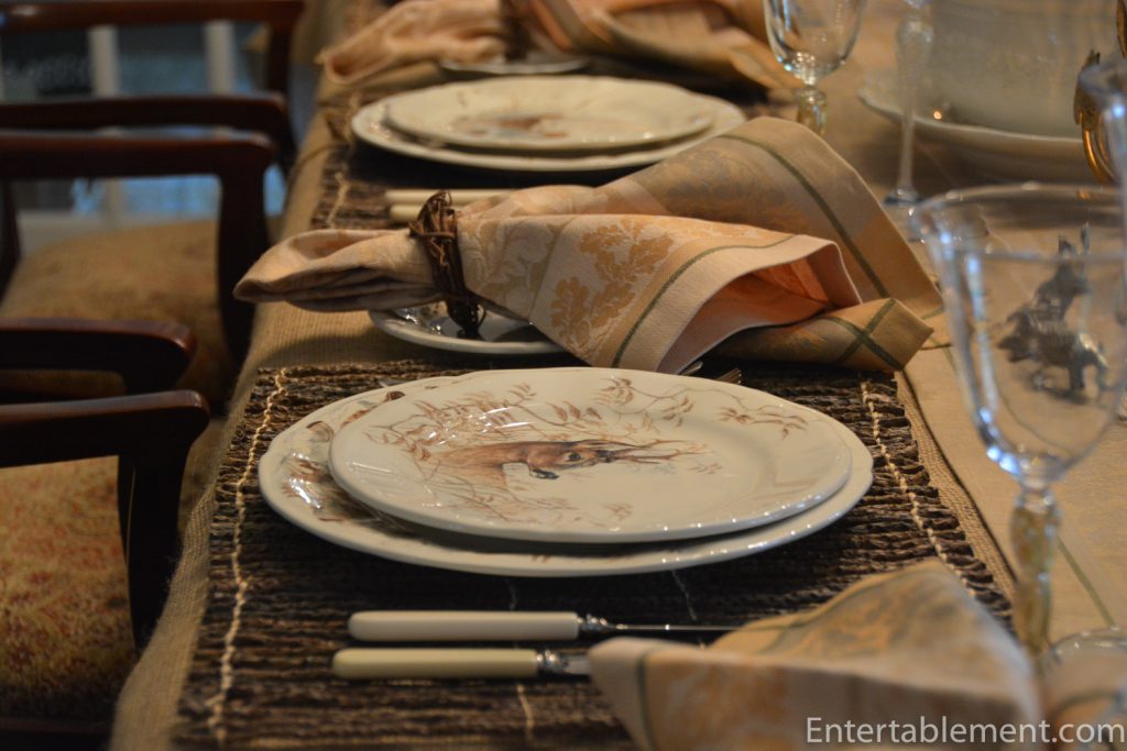 Gien Sologne faience plate with painted woodland animals and autumn foliage border.