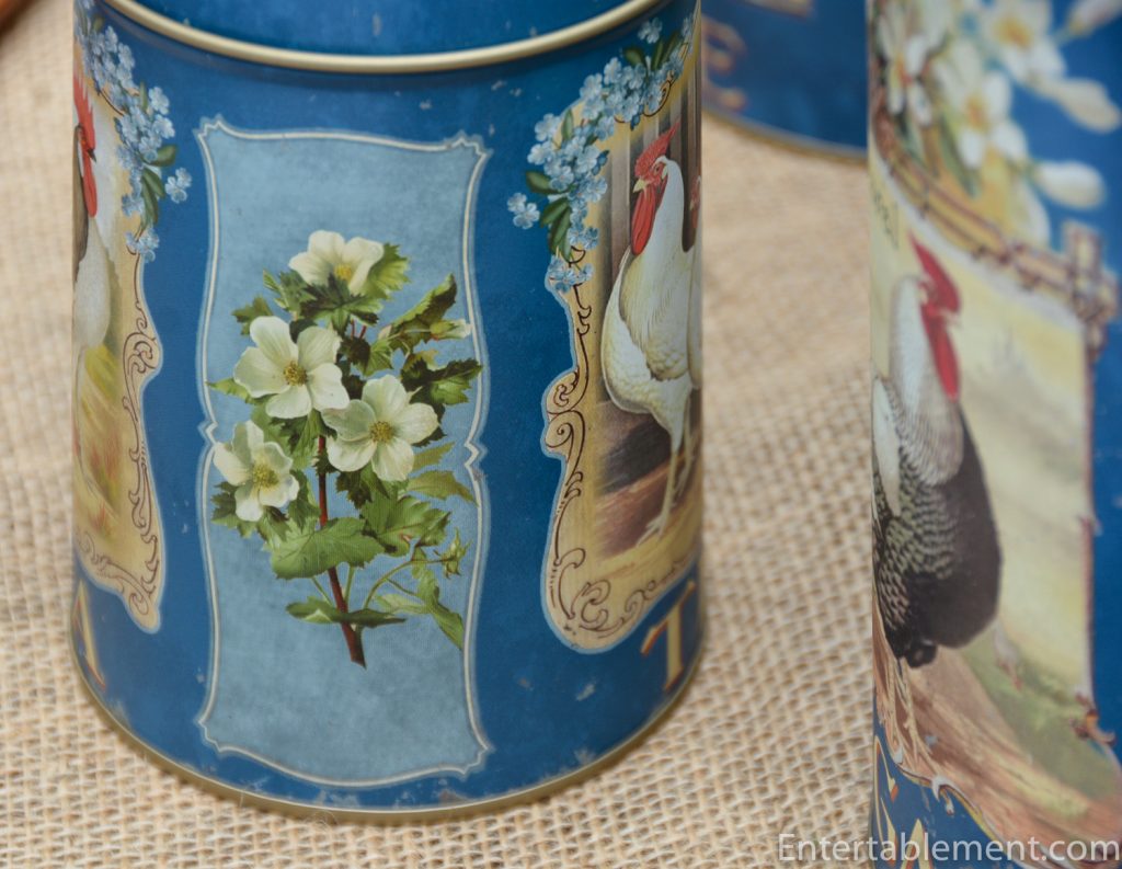 flowers on sides of blue canisters