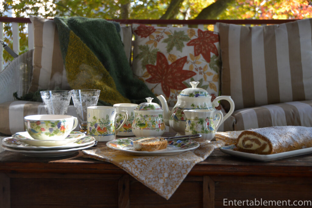 Tea setting of Gien Villa de Medicis pattern with background of autumn leaves.