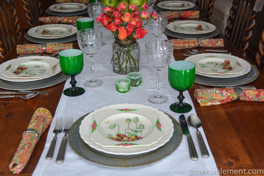 Table setting with Royal Doulton “Poppy” plate, Spode Jewel dinner plate, and vintage green glassware.
