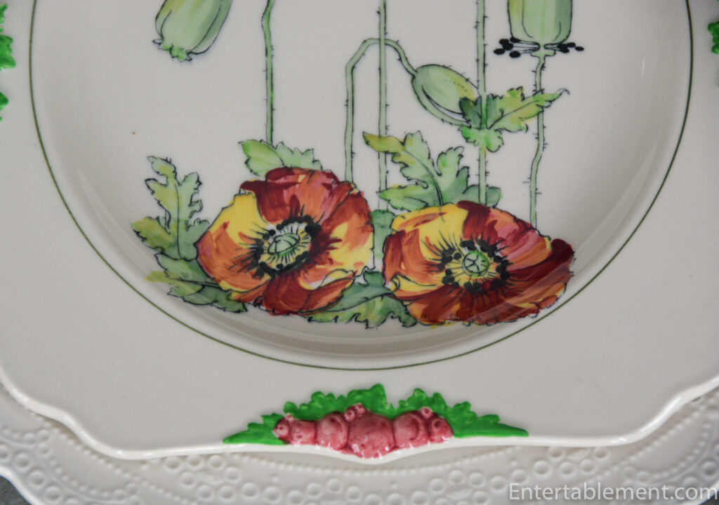 Close-up of Royal Doulton “Poppy” plate showing vivid poppies and crescent moon detail.