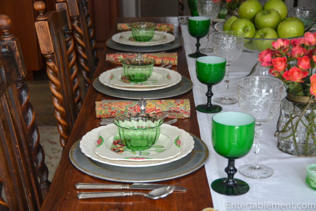 Table setting featuring a Royal Doulton “Poppy” plate, a Spode Jewel dinner plate, and vintage green glassware.