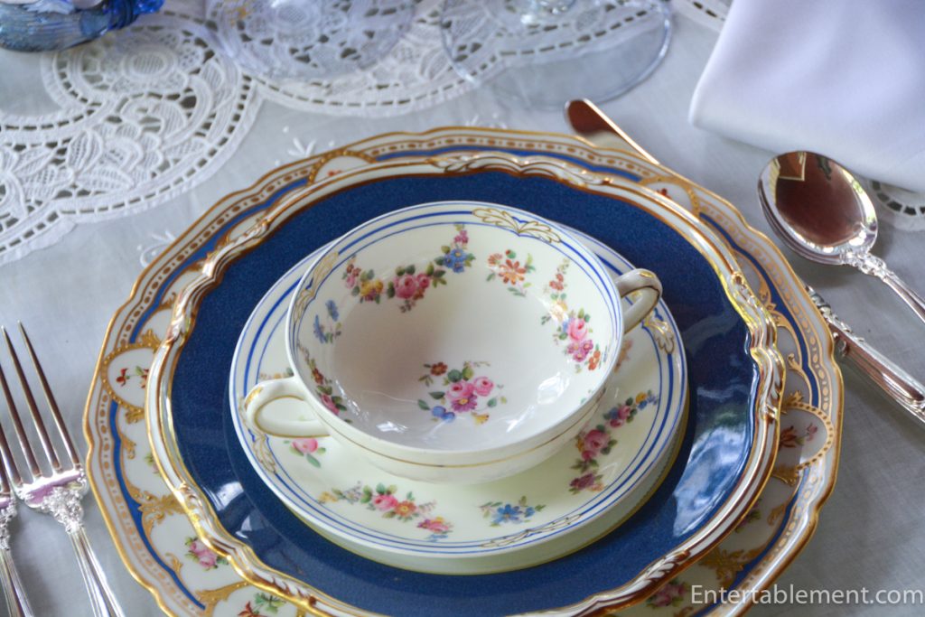 Close-up of Spode R7287 plate and soup cup H4092 atop a Wm. Guerin Limoges service plate with scalloped edge.