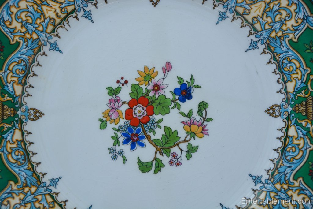 Johnson Brothers Garfield (Pareek) dinner plate with floral centerpiece and ornate green and gold border.