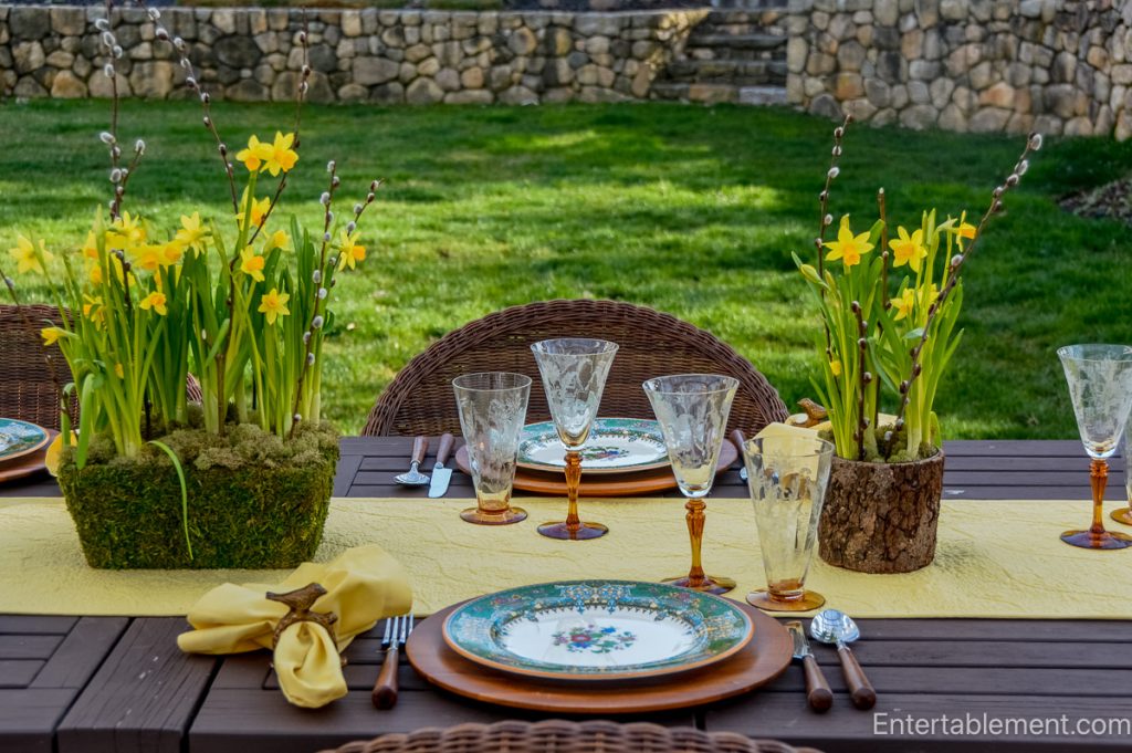 Garden party table set with Garfield Pareek china, Julia amber stemware, and yellow floral centerpieces.