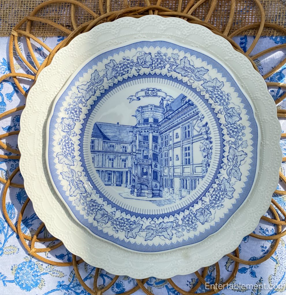 Layered architectural styles of Château de Blois on a Gien plate with soft blue tones.