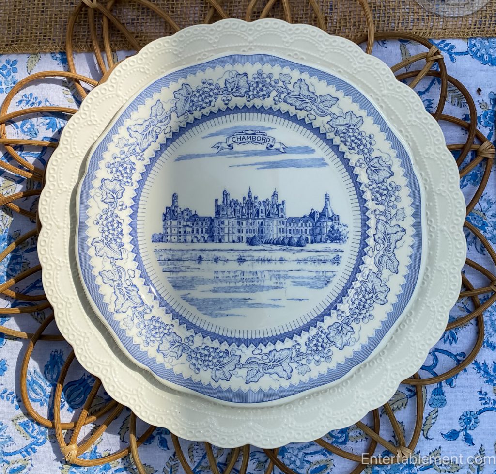 Gien plate depicting Château de Chambord in blue transferware with grapevine border