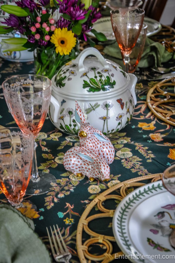 Decorative porcelain rabbits near a Portmeirion soup tureen with floral and butterfly motif.