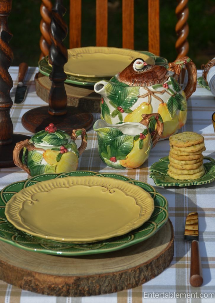 Fitz & Floyd Woodland Patridge and Pear teapot with matching cream jug and sugar bowl on an outdoor plaid tablescape.