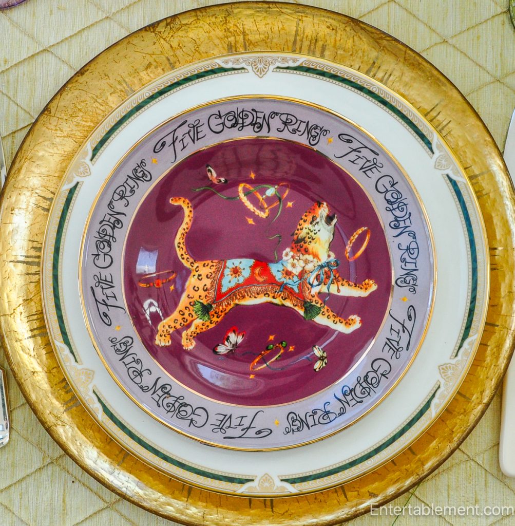 Anthropologie ‘Five Golden Rings’ plate featuring whimsical leopard juggling golden rings on deep plum background.