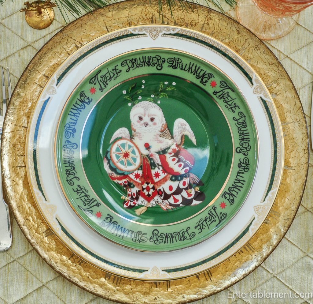 Anthropologie ‘Twelve Drummers Drumming’ plate with richly coloured drummer motif on green background.