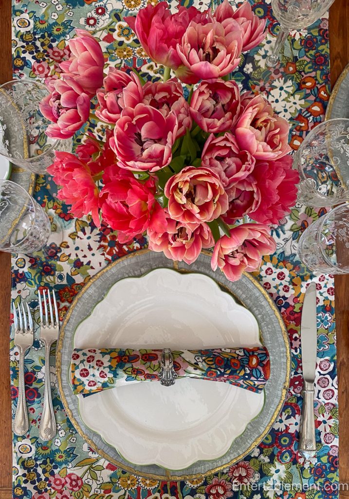 Table with colourful linens and floral arrangement adding a pop of favourite colour