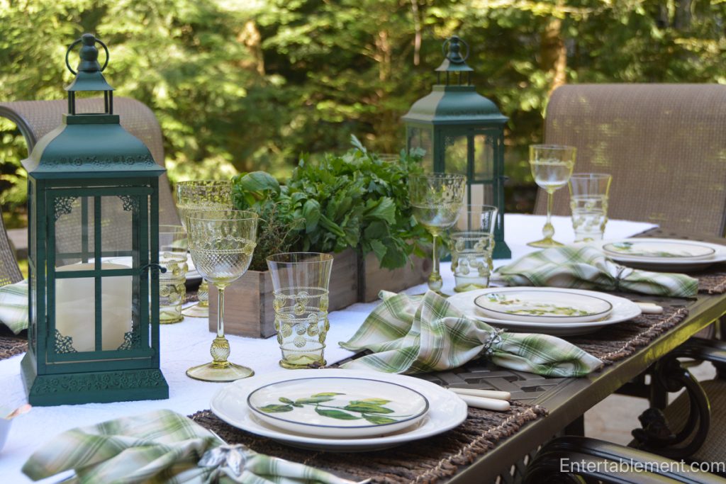 Centrepiece of simple greenery and branches used to enhance a table without fuss