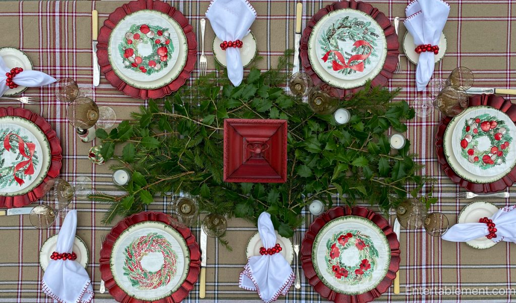 Centrepiece of simple greenery and branches used to enhance a table without fuss