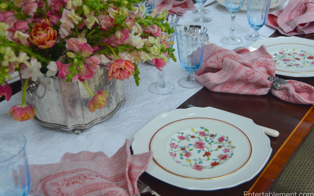 Close-up of Royal Worcester Astley plate with pink tulips and snapdragon centrepiece