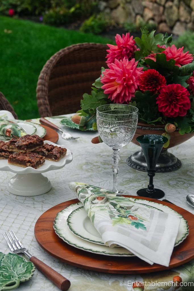 Late-summer table with garden dahlias and acorns, Williamsburg Green china, crystal goblets and green glasses.