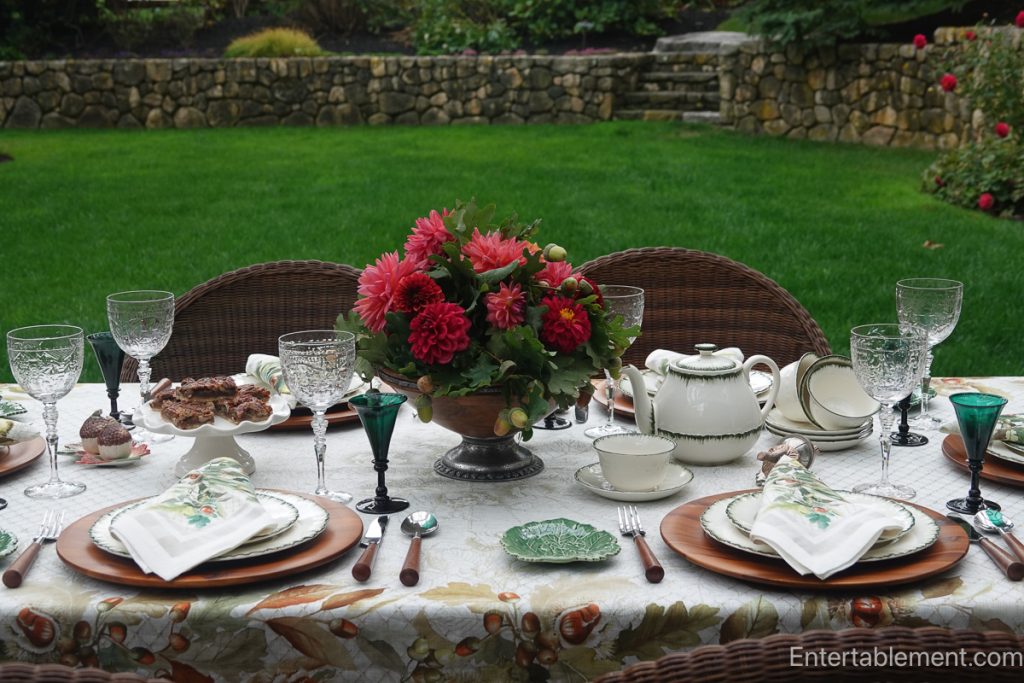 Garden dahlias and acorns form a colourful centrepiece beside a Wedgwood Williamsburg Green teapot and cup.