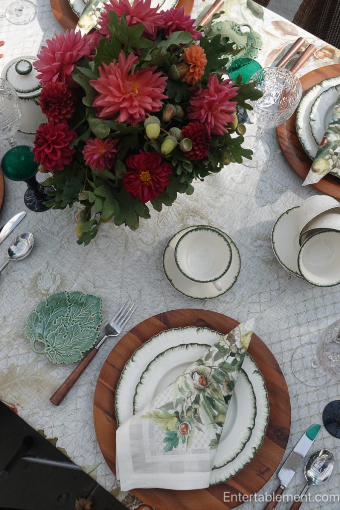 Williamsburg Green china layered with a Chestnut-patterned napkin, wooden charger and green leaf dish.