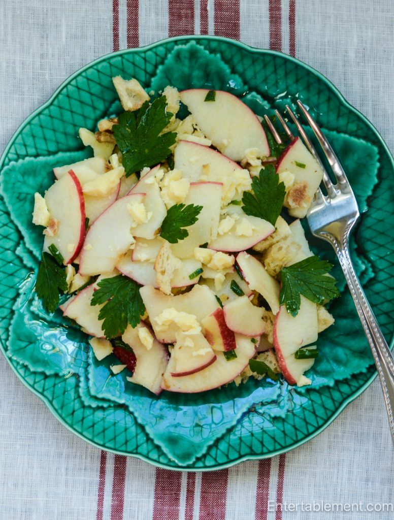 Savoury Apple Panzanella and fresh herbs served on a vintage Gien green majolica plate.