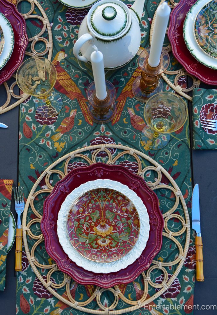 Morris & Co. Essex place setting with burgundy china, rattan charger and bamboo-handled flatware